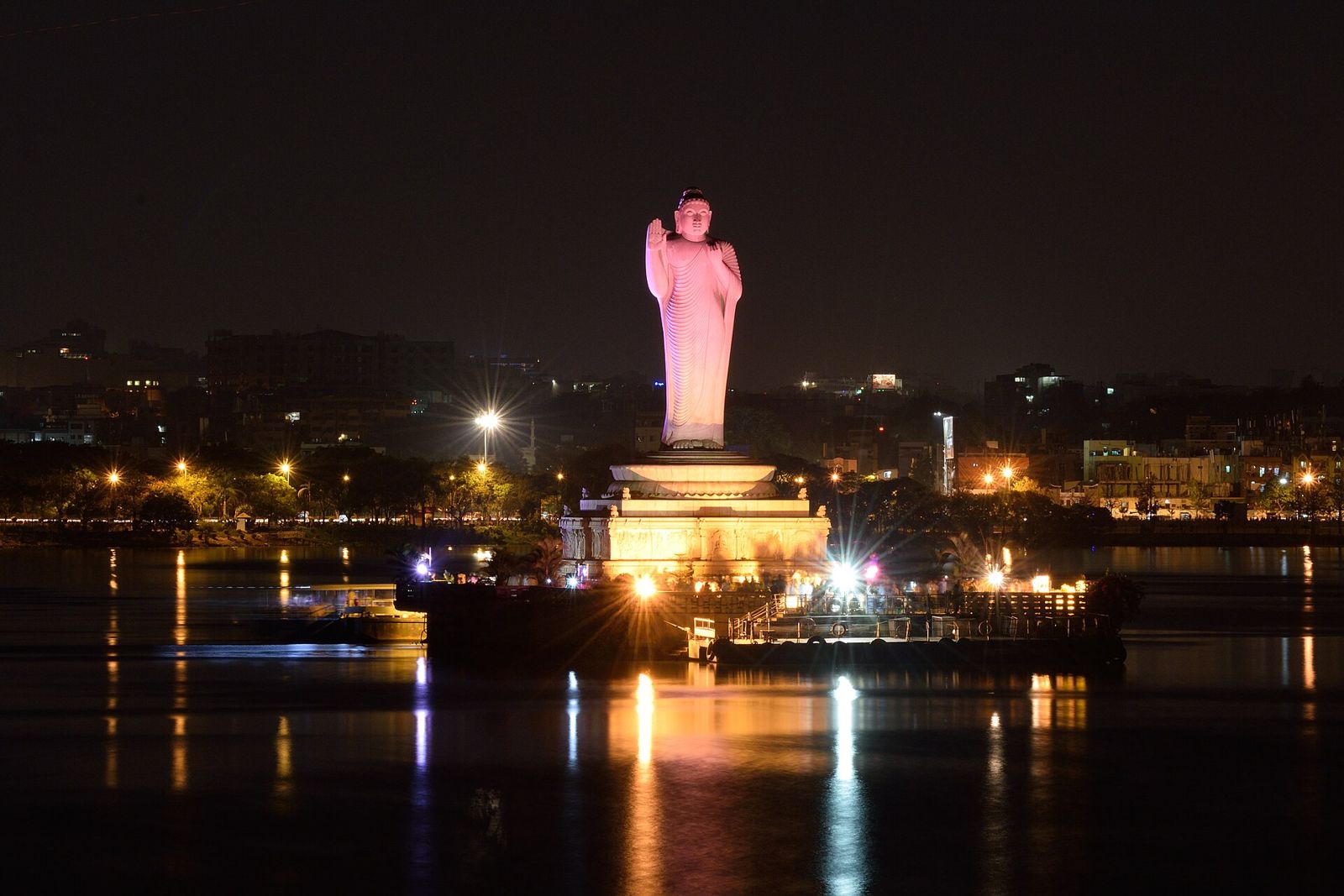 The Buddha statue lit up at night on Hussain Sagar lake in Hyderabad