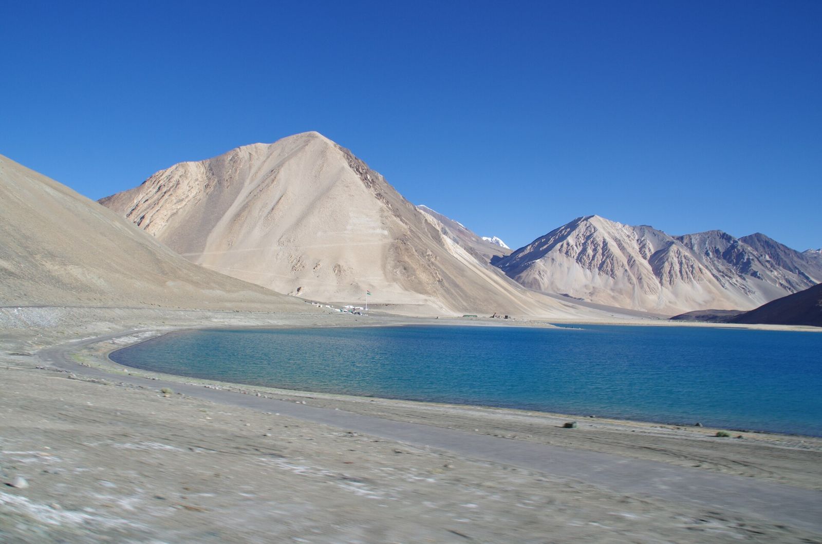 The blue water of Pangong Tso under bare mountains in Ladakh